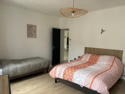 a bedroom with a bed and a mirror and a lamp at Appartement 100 m carré pour 6 à 8 personnes in Saint-Cannat