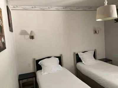 two beds in a room with white sheets and pillows at Hotel D'Albion in Sault-de-Vaucluse