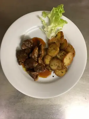 a plate of food with meat and potatoes and lettuce at Hotel D'Albion in Sault-de-Vaucluse
