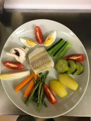 a plate of food with vegetables on a table at Hotel D'Albion in Sault-de-Vaucluse