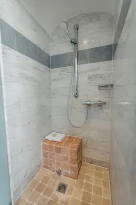 a bathroom with a shower with a brick box in it at La Bastide de Paula in Aix-en-Provence