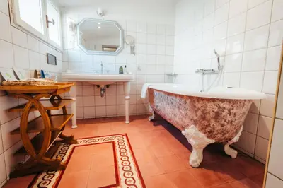 a bathroom with a bath tub and a sink at La Bastide de Paula in Aix-en-Provence
