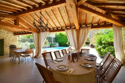 a large dining room with a table and chairs at Le moulin vieux, mas authentique en Provence avec piscine in Entraigues-sur-la-Sorgue