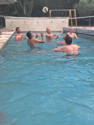 a group of men in a swimming pool with a volleyball at Coeur des Hommes in Le Thor