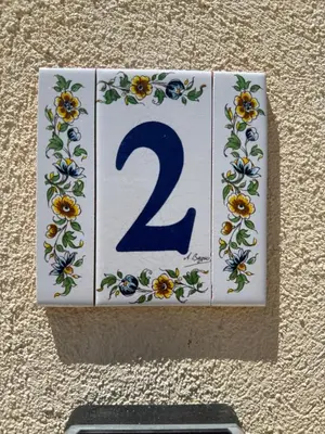 a plaque with a number on a wall at Charmants duplex , Clim et Piscine in Aix-en-Provence