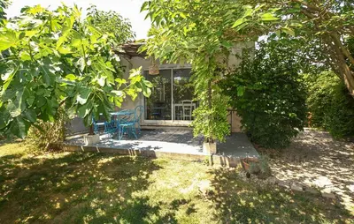 a house with a porch with a table and chairs at Maison Avec Jacuzzi in Mazan