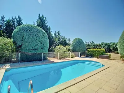 a swimming pool in a yard with trees at La Villa Luberonnaise in Robion en Luberon