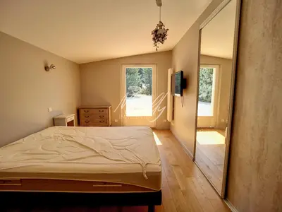 a bedroom with a bed and a large mirror at La Villa Luberonnaise in Robion en Luberon