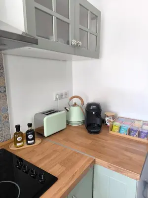 a kitchen with a wooden counter top with a tea kettle at Maison au coeur de Banon in Banon