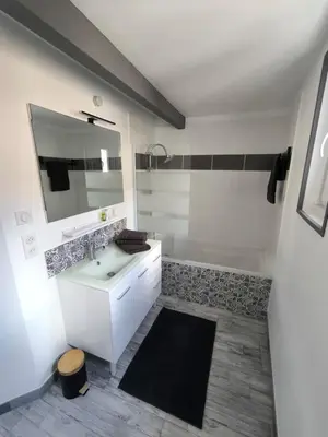 a white bathroom with a sink and a tub at Maison au coeur de Banon in Banon