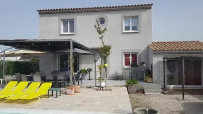 a patio with yellow chairs and a building at Beautiful Villa Pool in Provence in Monteux