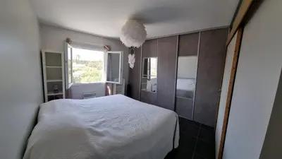 a bedroom with a white bed and a window at Beautiful Villa Pool in Provence in Monteux