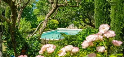a swimming pool in a yard with trees and flowers at Villa de charme avec Piscine & Vue panoramique en plein Centre-ville d'Aix-en-Provence in Aix-en-Provence