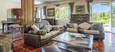 a living room with couches and a glass table at Villa de charme avec Piscine & Vue panoramique en plein Centre-ville d'Aix-en-Provence in Aix-en-Provence