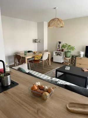 a living room with a table and a dining room at Quiet cozy apartment in Aix-en-Provence