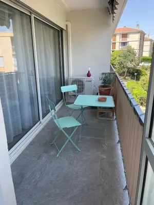 a patio with a table and chairs on a balcony at Quiet cozy apartment in Aix-en-Provence