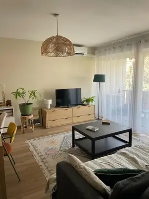 a living room with a couch and a coffee table at Quiet cozy apartment in Aix-en-Provence