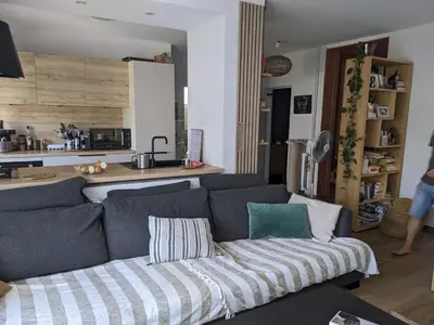 a living room with a couch and a kitchen at Quiet cozy apartment in Aix-en-Provence