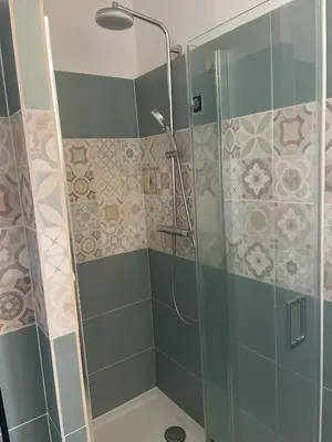 a shower with a glass door in a bathroom at Quiet cozy apartment in Aix-en-Provence