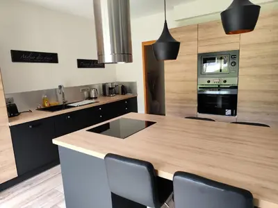 a kitchen with a wooden counter top and a stove top oven at Aloha in Aix-en-Provence