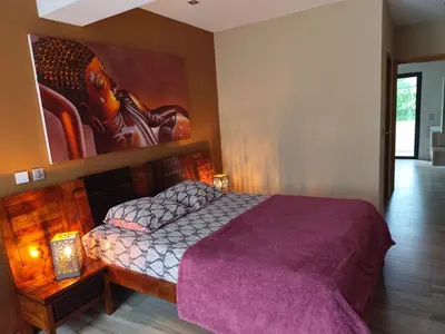 a bedroom with a bed with a painting on the wall at Aloha in Aix-en-Provence