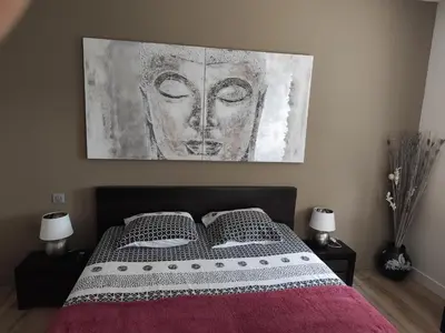 a bedroom with a bed with a painting on the wall at Aloha in Aix-en-Provence