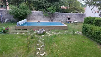 a backyard with a swimming pool in a yard at Appartement dans maison de caractère avec piscine in Banon