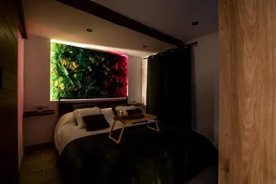a bedroom with a bed with a large painting on the wall at Studio cosy I Centre historique in Cavaillon