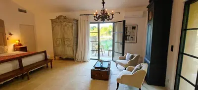 a bedroom with a bed and a living room at Peaceful Studio With Private Pool In Luberon in Ansouis