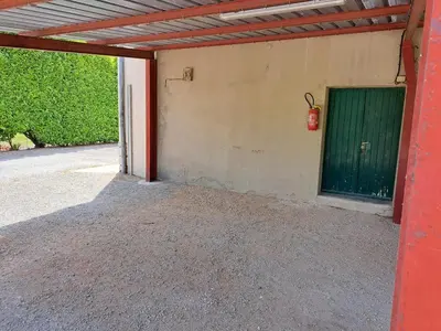 a garage with a green door and a green at Parenthèse à la Maison de Gilda in Eygalières