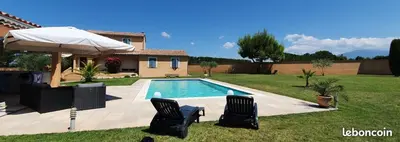 a swimming pool with two chairs and an umbrella at Gite confort et Calme Casa La Piboulette in Carpentras