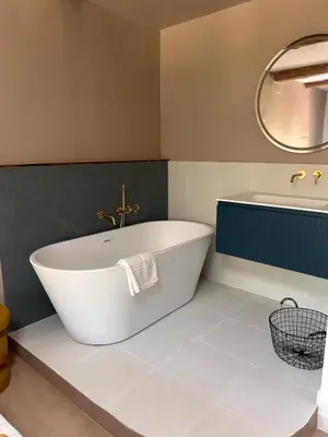 a bathroom with a white tub and a sink at La Maison Du Jas in Puyvert