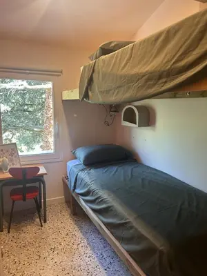 a bedroom with two bunk beds and a desk at La Maison Du Jas in Puyvert