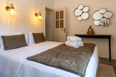 a bedroom with a large bed with towels on it at Gîte Terrasse in Gordes