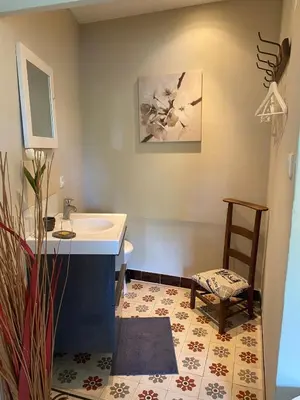 a bathroom with a sink and a chair at La Rochère - Hamlet with swimming pool in Gordes in Gordes