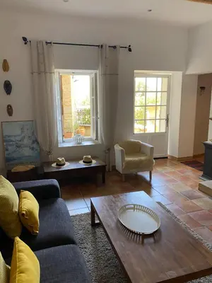 a living room with a couch and a coffee table at La Rochère - Hamlet with swimming pool in Gordes in Gordes