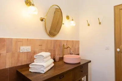 a bathroom with a sink and a mirror at Terres Élaïs in Robion en Luberon