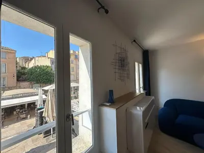 a room with a window with a view of a city at Le Nid des Cardeurs studio cosy centre historique in Aix-en-Provence