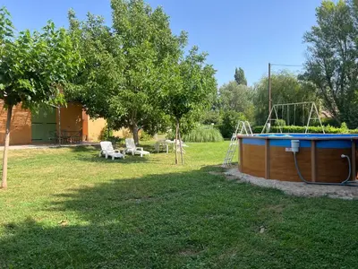 a backyard with a pool and a swing at Maison familiale Luberon in Lauris
