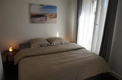 a bed in a bedroom with a window at Appart Suite Privilege XL avec Parking in Salon-de-Provence