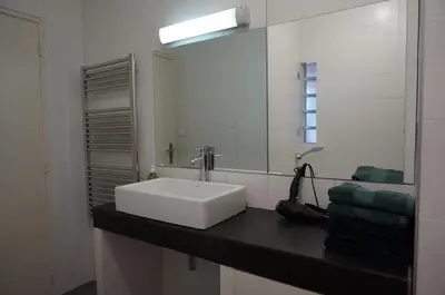 a bathroom with a white sink and a mirror at Appart Suite Privilege XL avec Parking in Salon-de-Provence