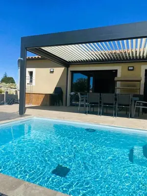 a large blue swimming pool with a patio at Friendly and warm villa with pool in Pernes-les-Fontaines