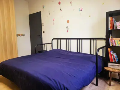a bedroom with a bed with a purple blanket at Friendly and warm villa with pool in Pernes-les-Fontaines