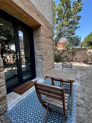 a wooden table and bench outside of a house at Studio Avignon MONTFAVET in Avignon