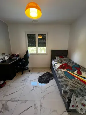 a bedroom with a bed and a desk and a window at Belle villa à Carpentras in Carpentras