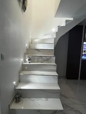 a stairway with white steps with lights on it at Belle villa à Carpentras in Carpentras