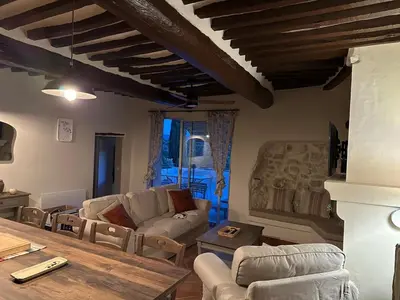 a living room with a couch and a table at Charming house in the village center of Venasque in Venasque