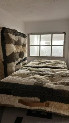 a bed in a room with a window at Maison au Cœur de Isle-sur-la-Sorgue in LʼIsle-sur-la-Sorgue