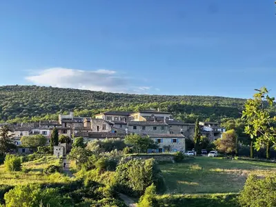 a group of houses on a hill in a field at maison de charme en Luberon in Gignac