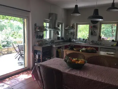 a kitchen with a table with a bowl of fruit on it at maison de charme en Luberon in Gignac